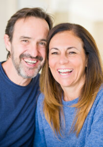 A man and woman smiling for the camera at Mill Villa Estates.
