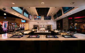 A bar at Black Oak Casino & Hotel with a large number of televisions.