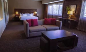 Black Oak Casino & Hotel offers a comfortable hotel room with a bed, couch, and television.