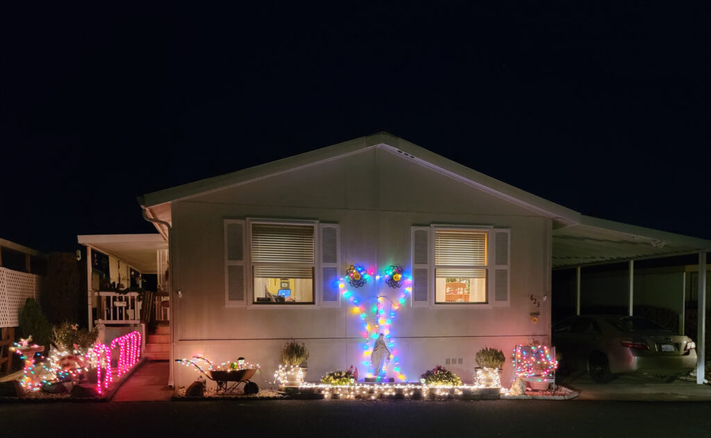 A mobile home is decorated with christmas lights.