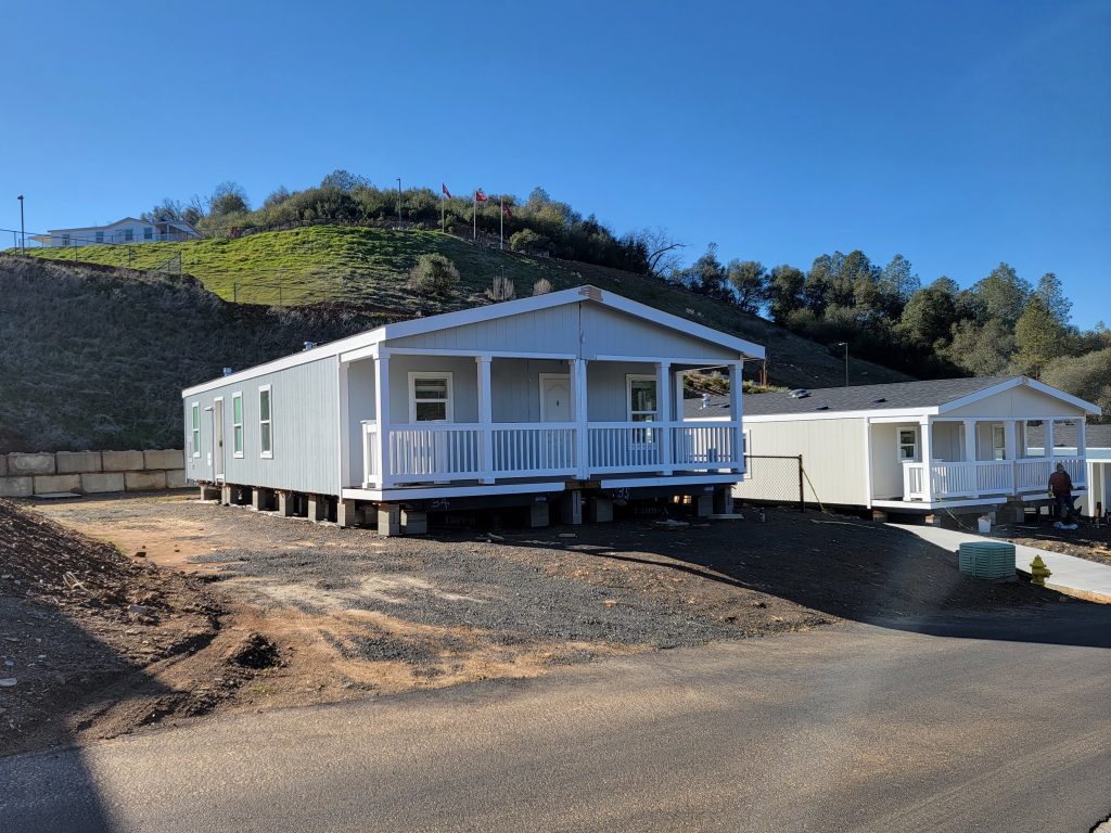 A mobile home is being built on a hillside.