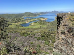 A view from the top of a cliff overlooking a lake during April Events in Tuolumne County.