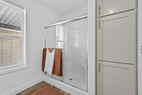 A bathroom with a shower stall and a towel rack.