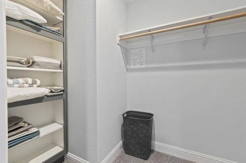 A walk in closet with towels and a basket.